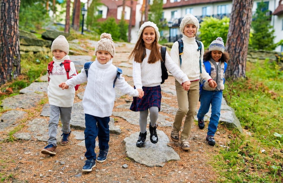 A group of children walking together outdoors